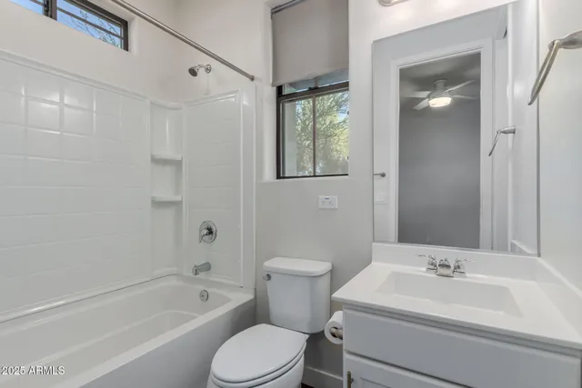 a bathroom with a toilet a sink and bathtub
