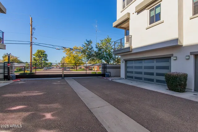 a roof deck with furniture and potted plants