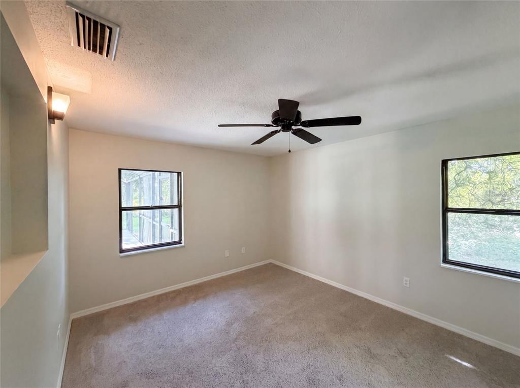 3739 Lake Griffin Road Lady Lake, FL 32159 - Photo 18 of 21 an empty room with windows and fan