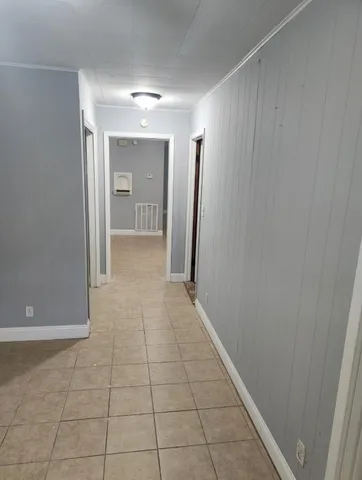 a view of hallway with an empty space and a window