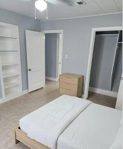 a bedroom with a bed and window