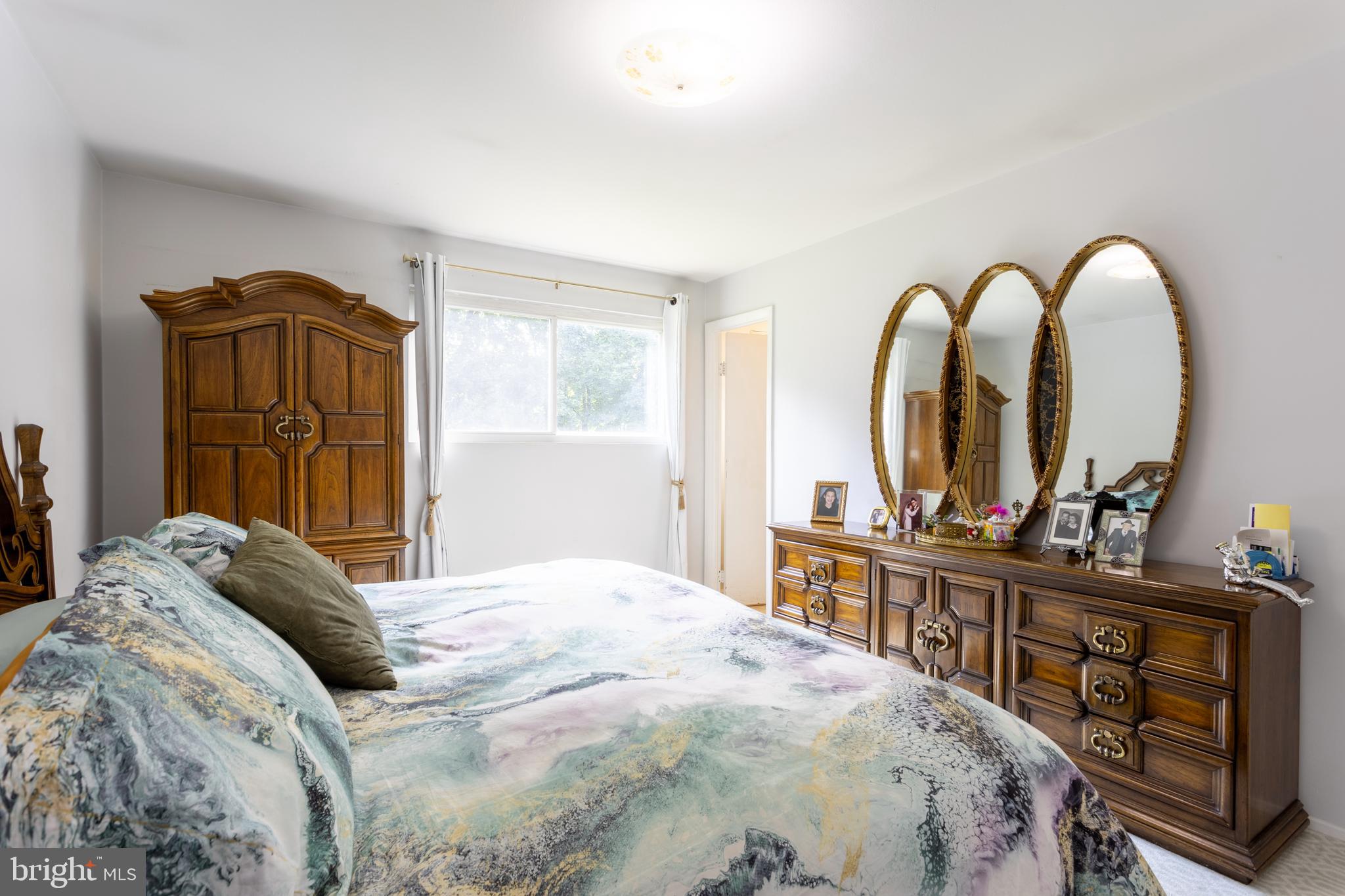 3313 Claran Road Baltimore, MD 21215 - Photo 15 of 35 a bedroom with a bed and a large mirror on the dresser