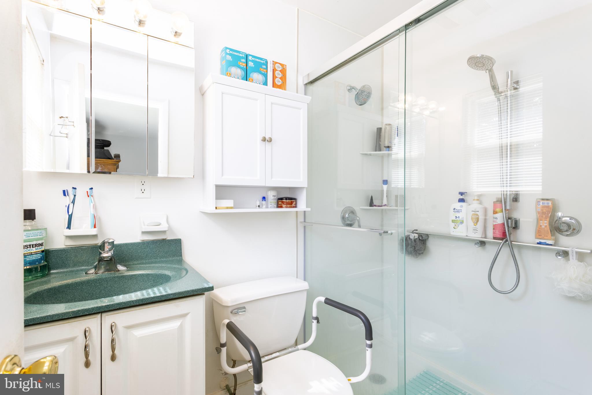 3313 Claran Road Baltimore, MD 21215 - Photo 16 of 35 a bathroom with a granite countertop sink a toilet and a mirror