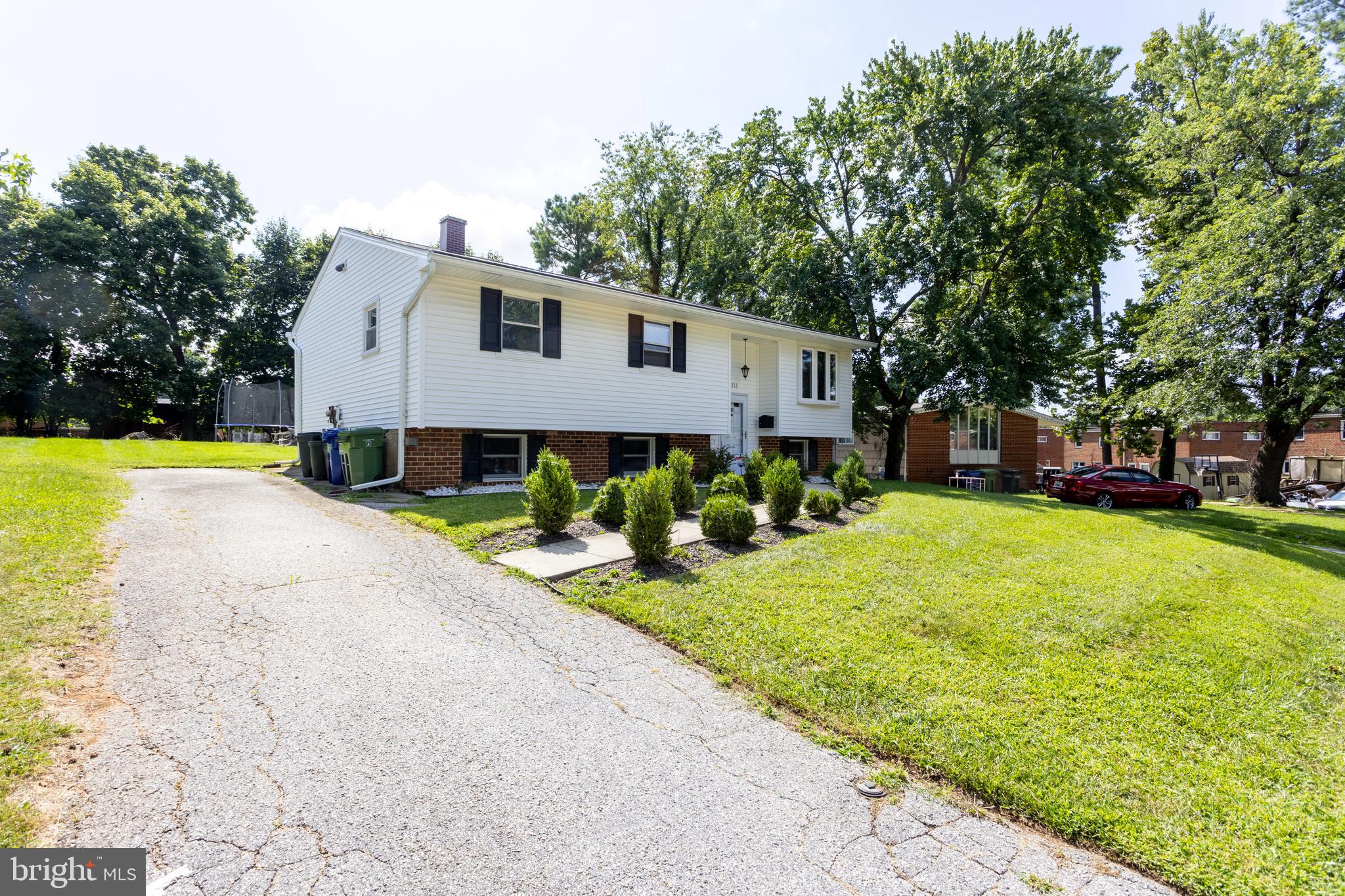 3313 Claran Road Baltimore, MD 21215 - Photo 2 of 35 a front view of a house with a yard and trees