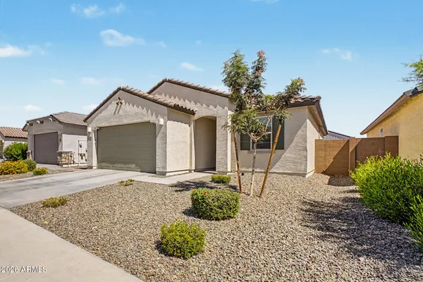 a front view of a house with garden