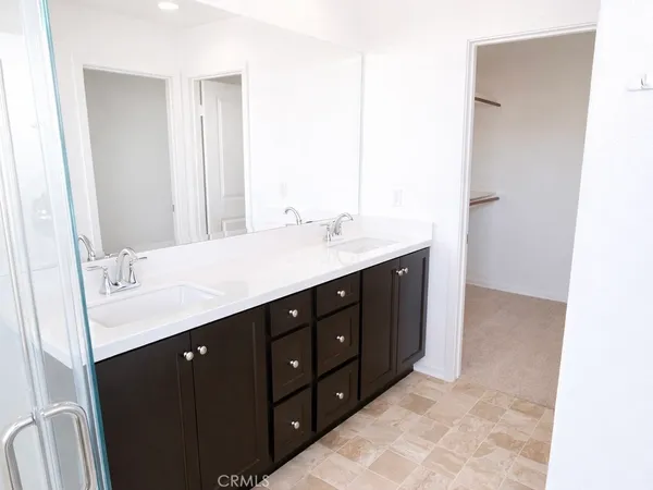 a bathroom with a double vanity sink and mirror