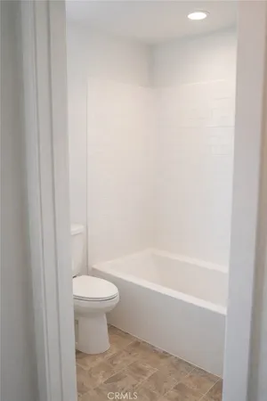 a bathroom with a bathtub and toilet