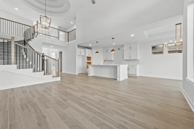 a kitchen with kitchen island a sink and wooden floor