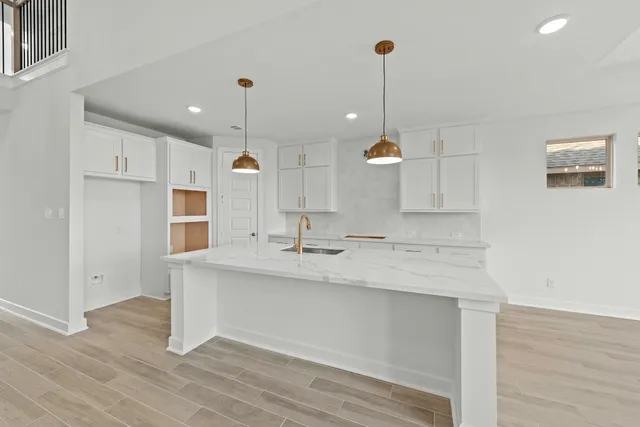 a view of a kitchen with a sink stainless steel appliances and cabinets