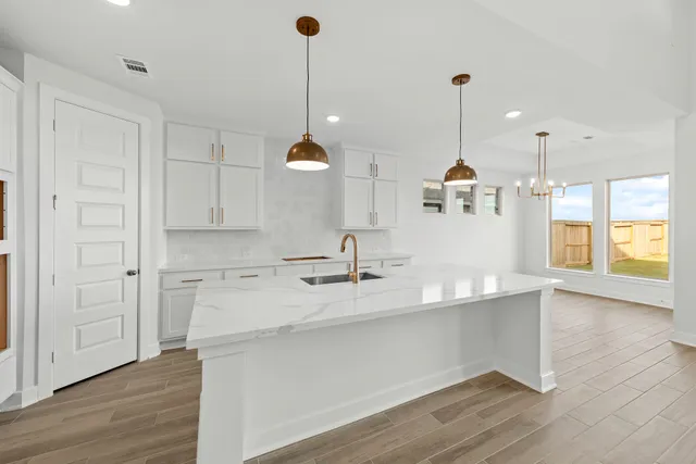 a kitchen with wooden floor and window