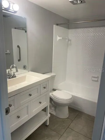 a bathroom with a double vanity sink mirror and toilet