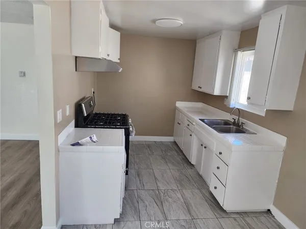a kitchen with cabinets a stove and a refrigerator