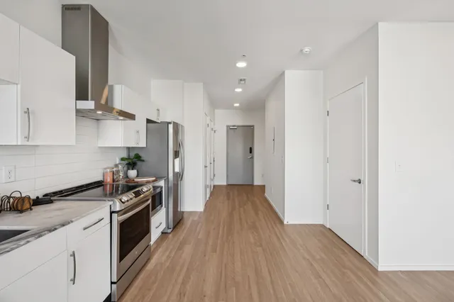 a kitchen with a sink a stove and refrigerator
