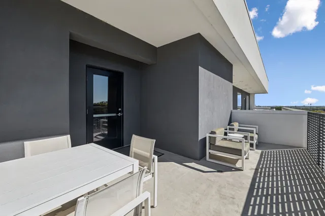 a kitchen with a table chairs and a refrigerator