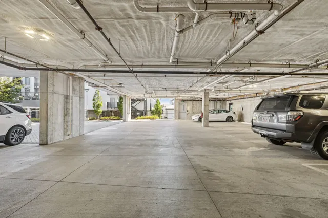 a view of parking garage with cars