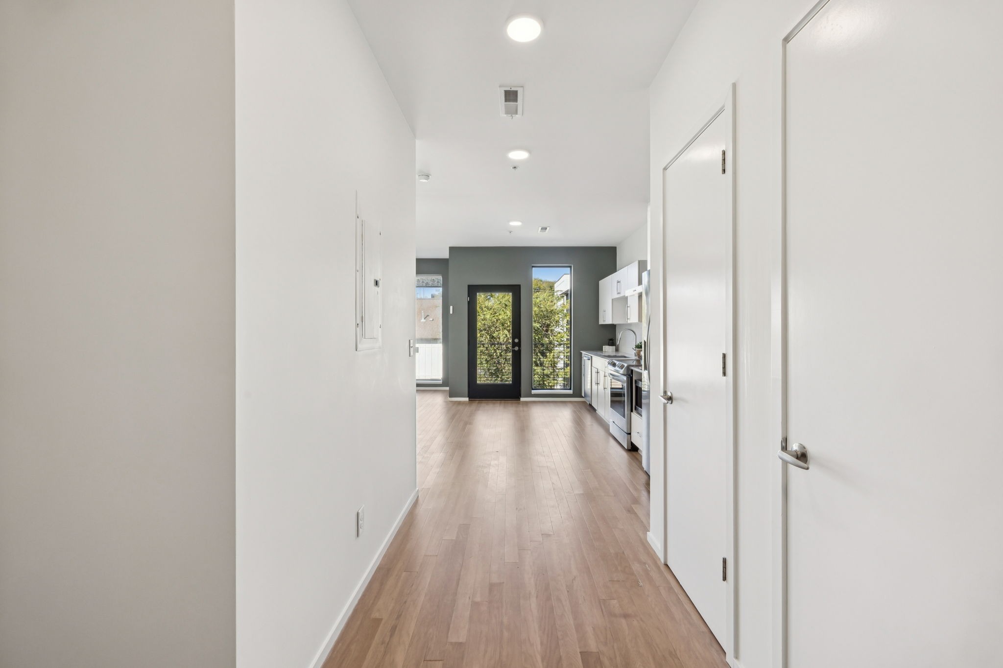 806 Olympic Street, Unit 407 Nashville, TN 37203 - Photo 6 of 28 a view of a hallway with wooden floor and a bathroom