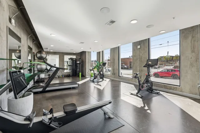 a room with gym equipment and a large window