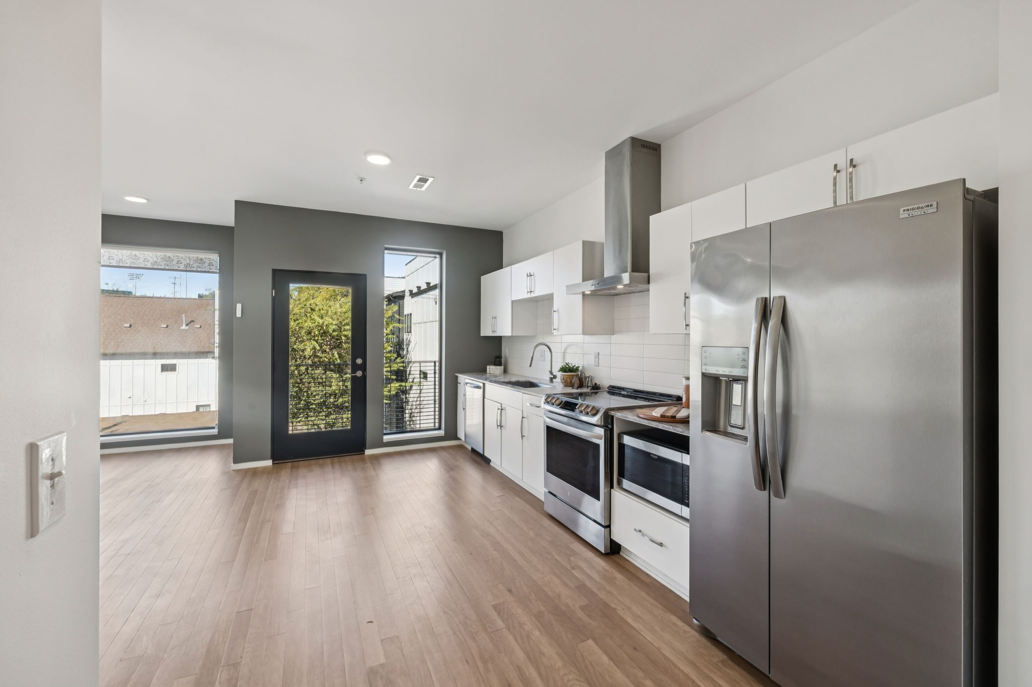 806 Olympic Street, Unit 407 Nashville, TN 37203 - Photo 7 of 28 a kitchen with stainless steel appliances a refrigerator and a stove top oven