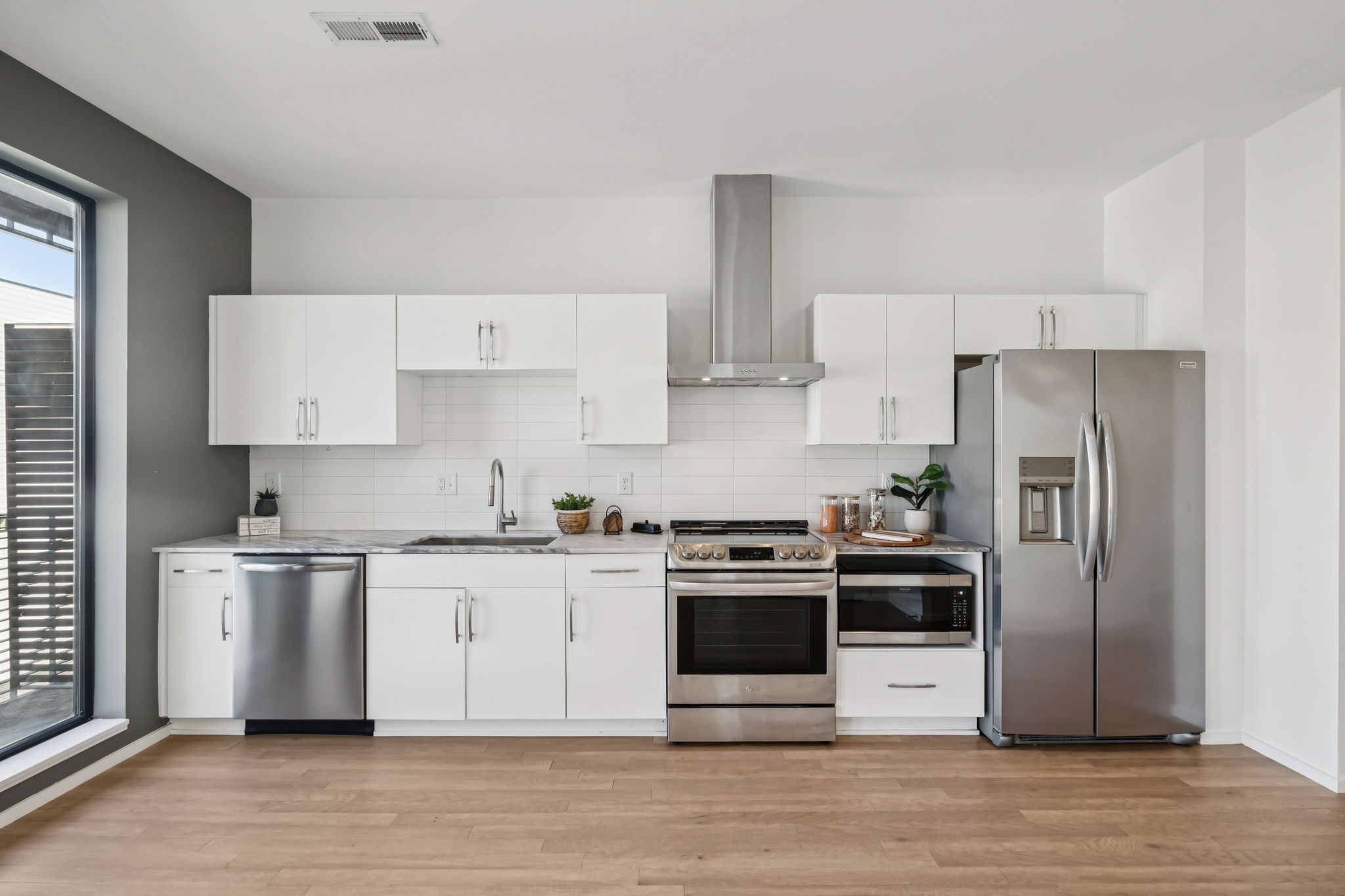 806 Olympic Street, Unit 407 Nashville, TN 37203 - Photo 8 of 28 a kitchen with stainless steel appliances and wooden cabinets