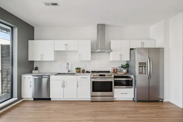 a kitchen with stainless steel appliances and wooden cabinets