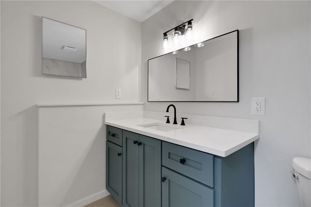 6259 Spring Lake Drive Flowery Branch, GA 30542 - Photo 22 of 35 a bathroom with a sink vanity and mirror
