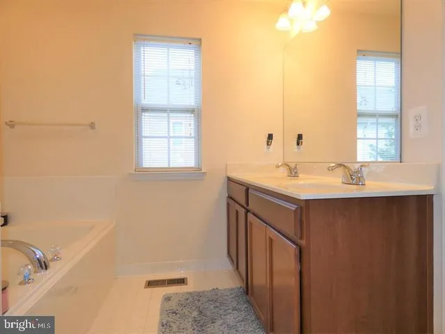 a bathroom with a sink a mirror and a bathtub