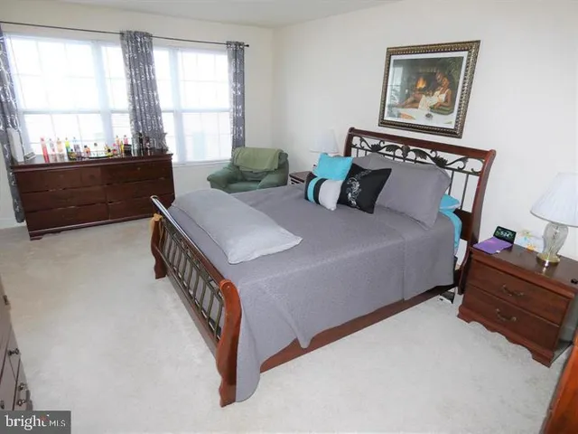 a bedroom with bed and a window