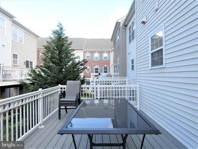a view of a chair and table on the wooden deck