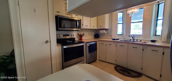 a kitchen with a sink stove and microwave
