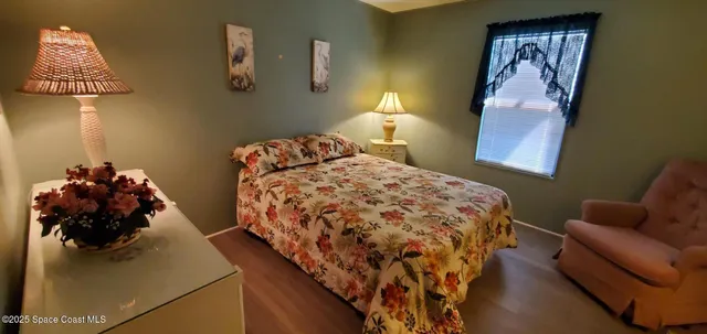 a bedroom with a bed and a lamp