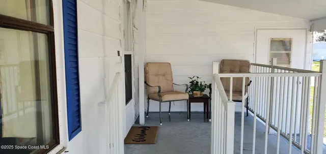 a view of a livingroom with furniture and stairs
