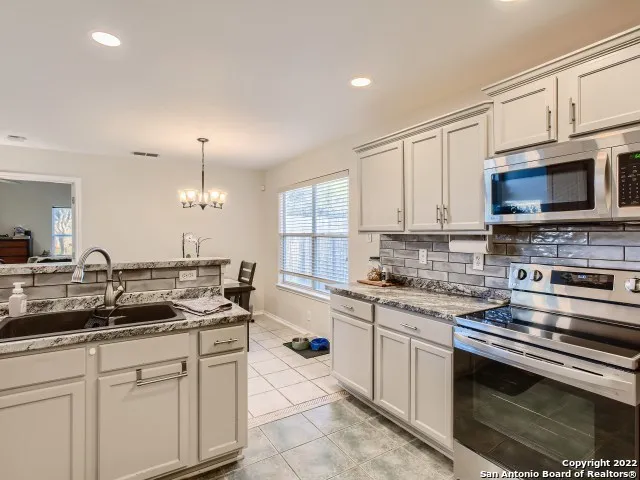a kitchen with stainless steel appliances granite countertop a sink and cabinets