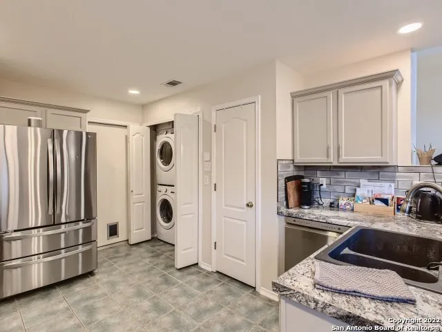 a kitchen that has a sink and a refrigerator