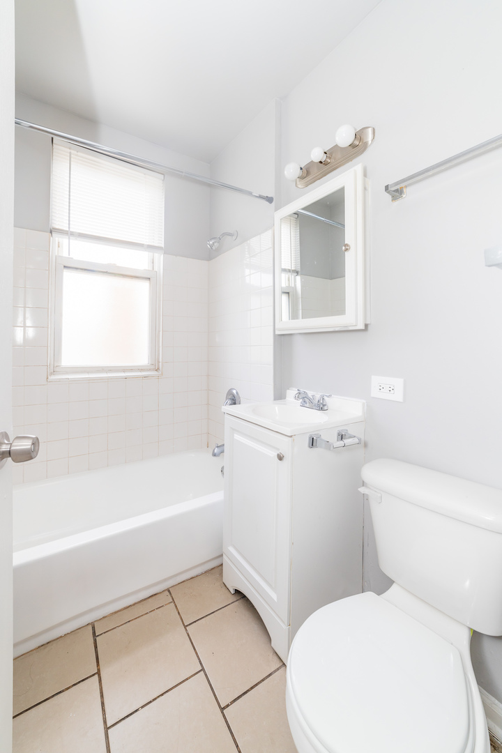 1229 East 71st Street Chicago, IL 60619 - Photo 11 of 14 a bathroom with a toilet sink and bathtub