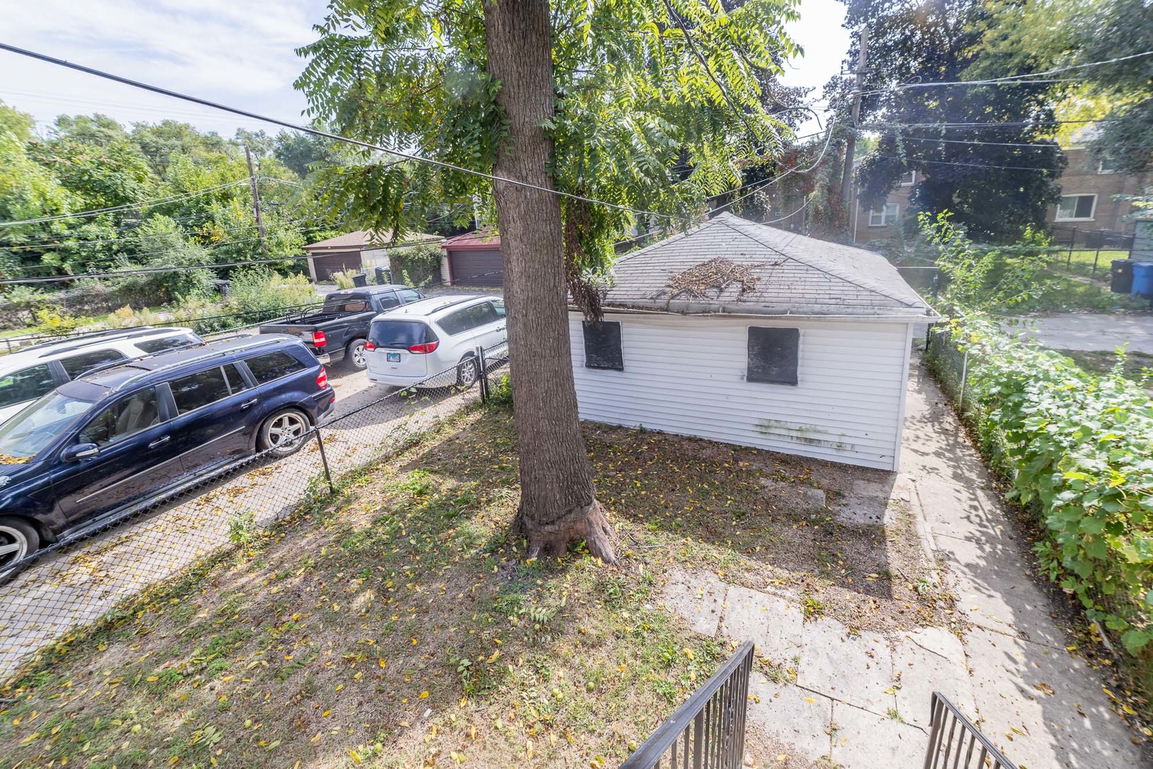 1229 East 71st Street Chicago, IL 60619 - Photo 13 of 14 a view of a house with a yard and a large tree