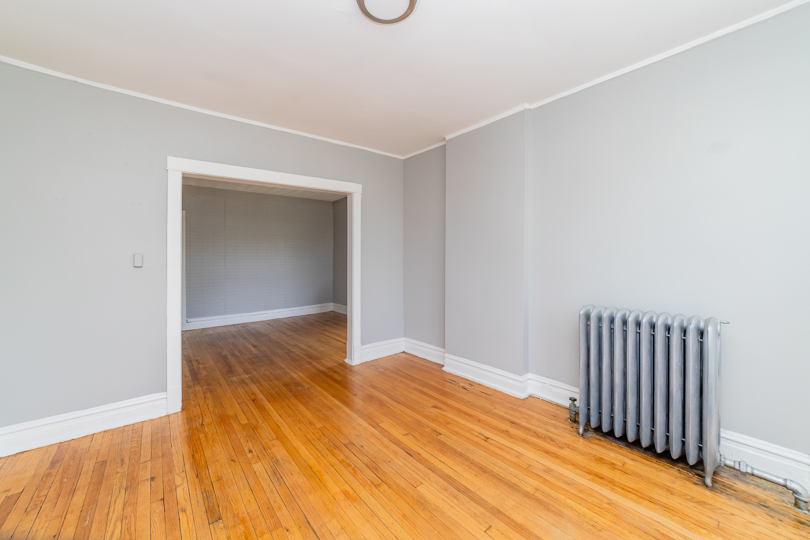1229 East 71st Street Chicago, IL 60619 - Photo 3 of 14 a view of a room with wooden floor & fence