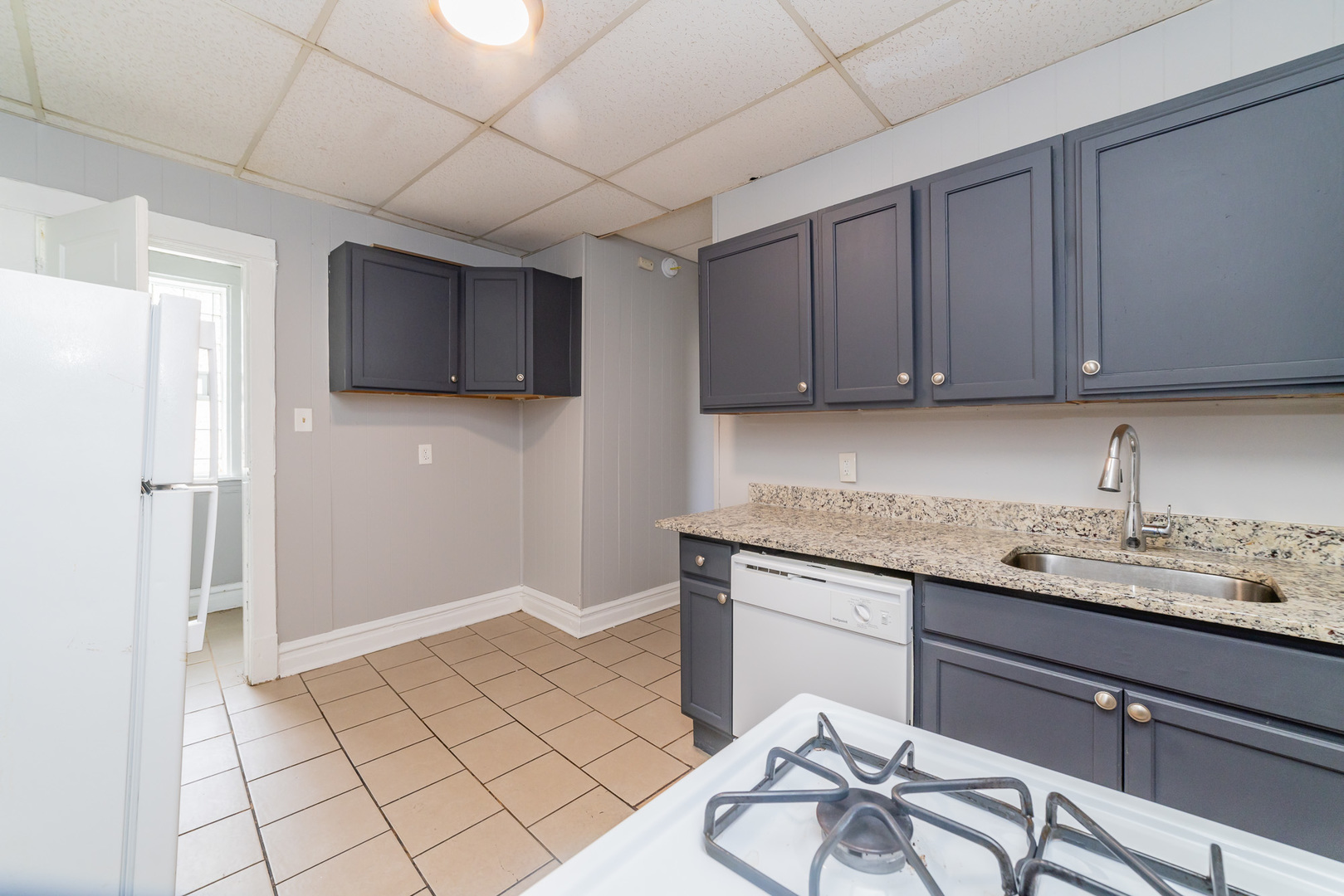 1229 East 71st Street Chicago, IL 60619 - Photo 7 of 14 a kitchen with a sink a stove and refrigerator
