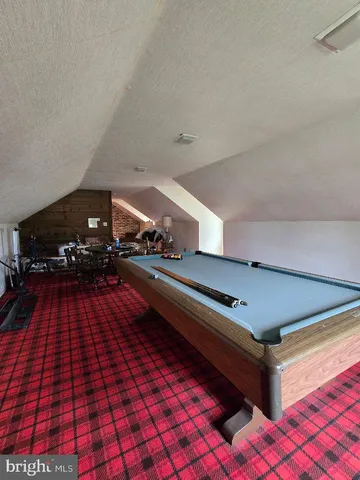 a view of a chairs and table in the backyard