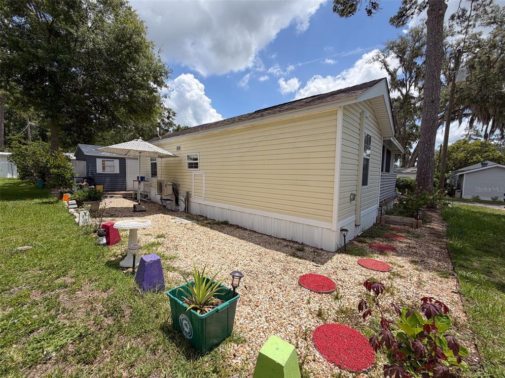 2092 Culbreath Road, Unit A42 Brooksville, FL 34602 - Photo 53 of 70 a view of a chairs and table in backyard of the house