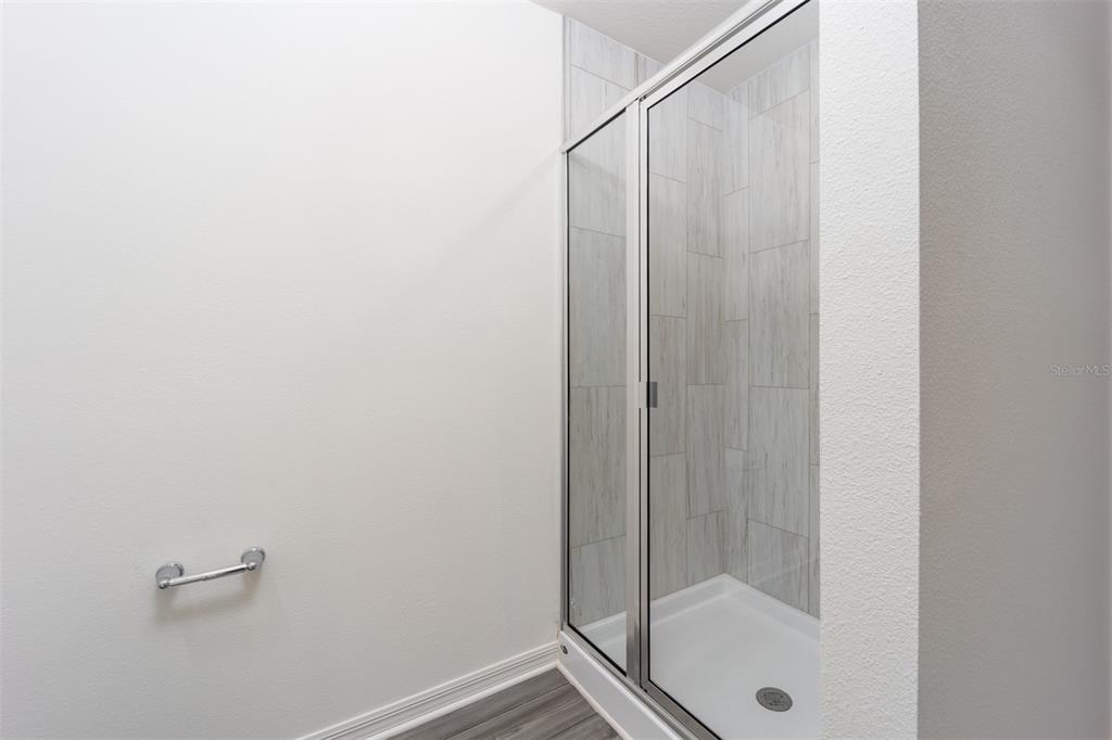 787 Poppy Lane Dundee, FL 33838 - Photo 12 of 16 a bathroom with a shower