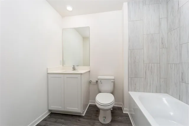 a bathroom with a toilet a sink and bathtub
