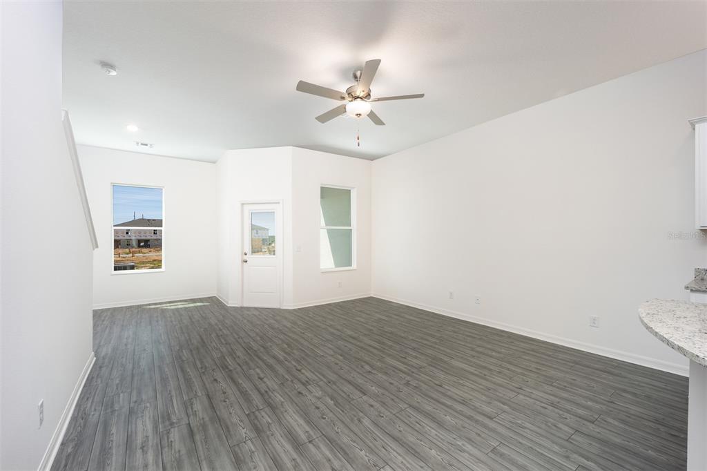 787 Poppy Lane Dundee, FL 33838 - Photo 7 of 16 wooden floor in an empty room with a window