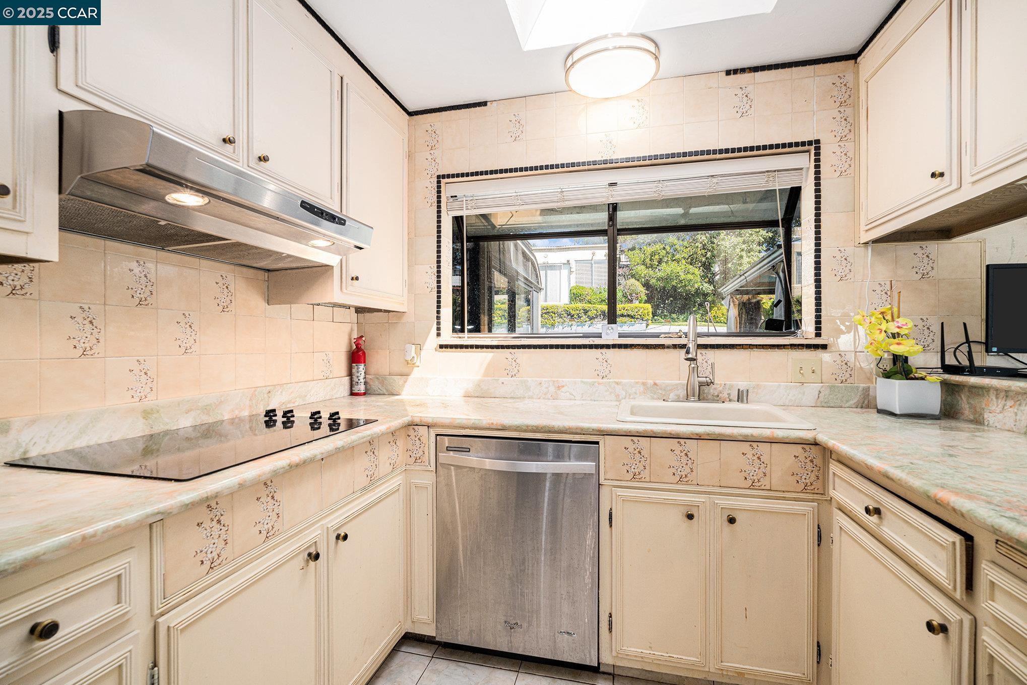 5955 Ralston Avenue Richmond, CA 94805 - Photo 12 of 47 a kitchen with cabinets appliances a sink and a window