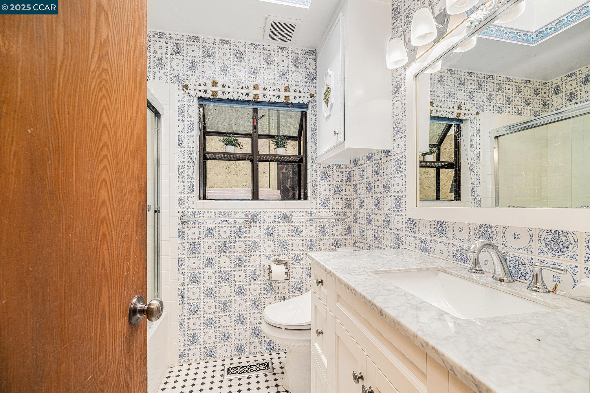5955 Ralston Avenue Richmond, CA 94805 - Photo 19 of 47 a bathroom with a granite countertop sink a large mirror and a shower