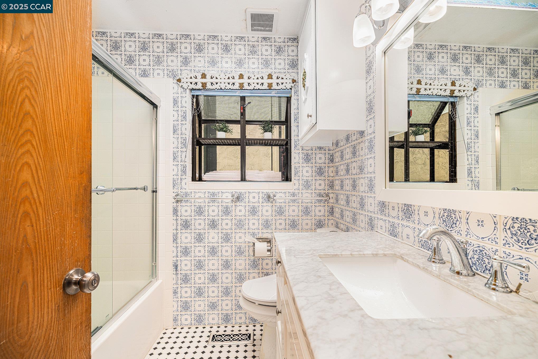 5955 Ralston Avenue Richmond, CA 94805 - Photo 20 of 47 a bathroom with a granite countertop sink a toilet and shower