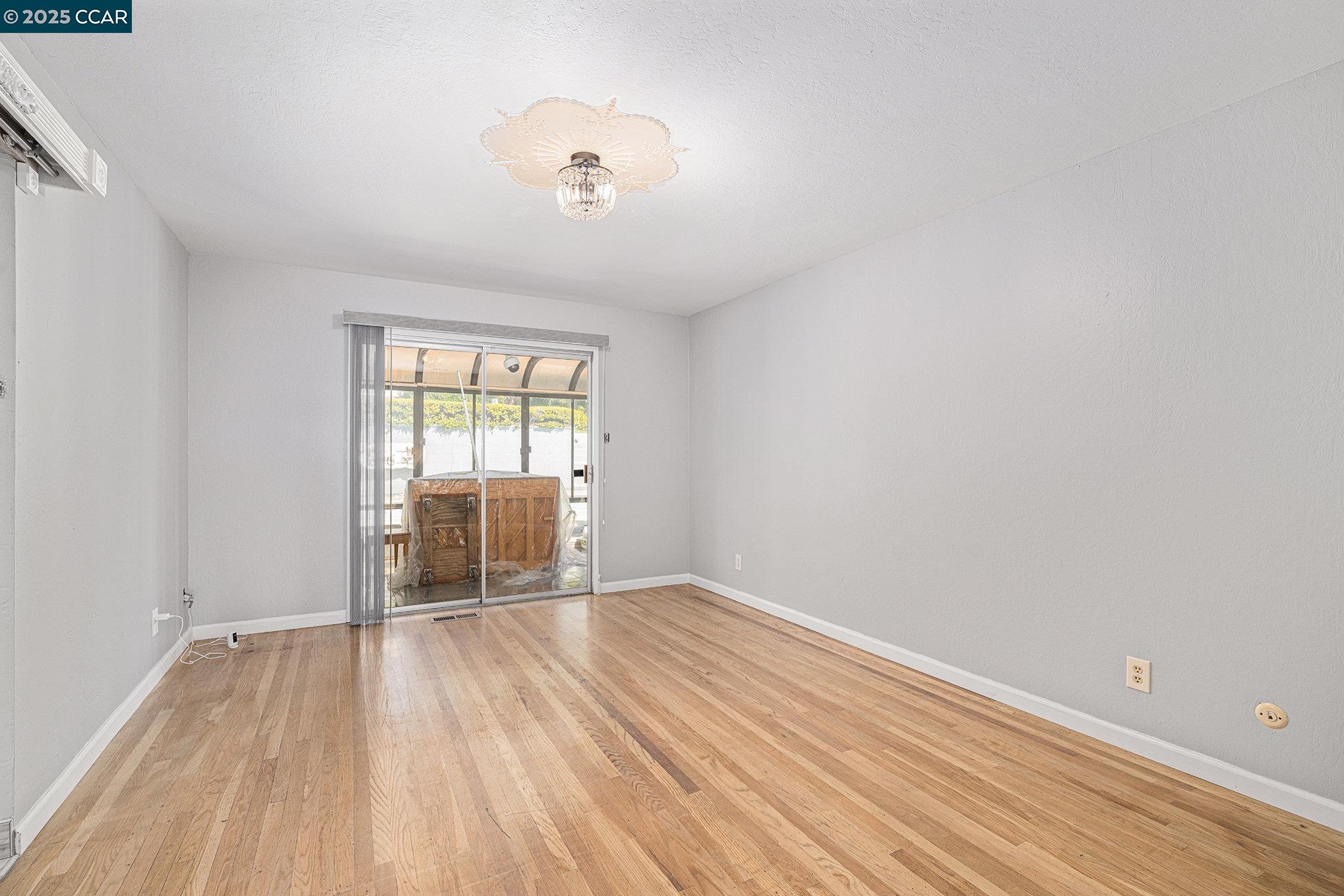 5955 Ralston Avenue Richmond, CA 94805 - Photo 21 of 47 an empty room with wooden floor and windows