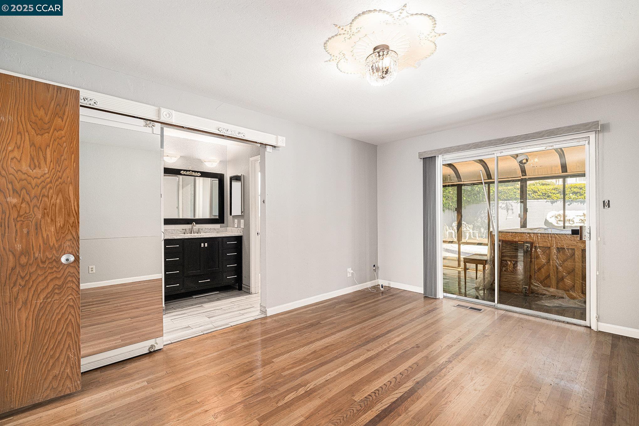 5955 Ralston Avenue Richmond, CA 94805 - Photo 23 of 47 an empty room with wooden floor and windows