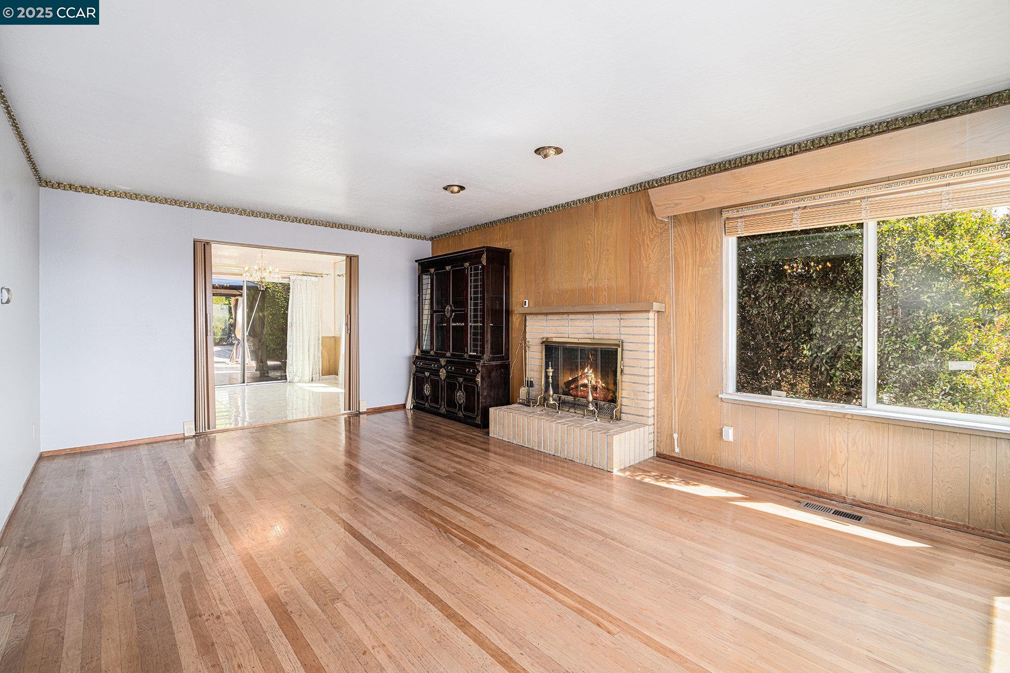 5955 Ralston Avenue Richmond, CA 94805 - Photo 3 of 47 a view of an empty room with wooden floor and a window