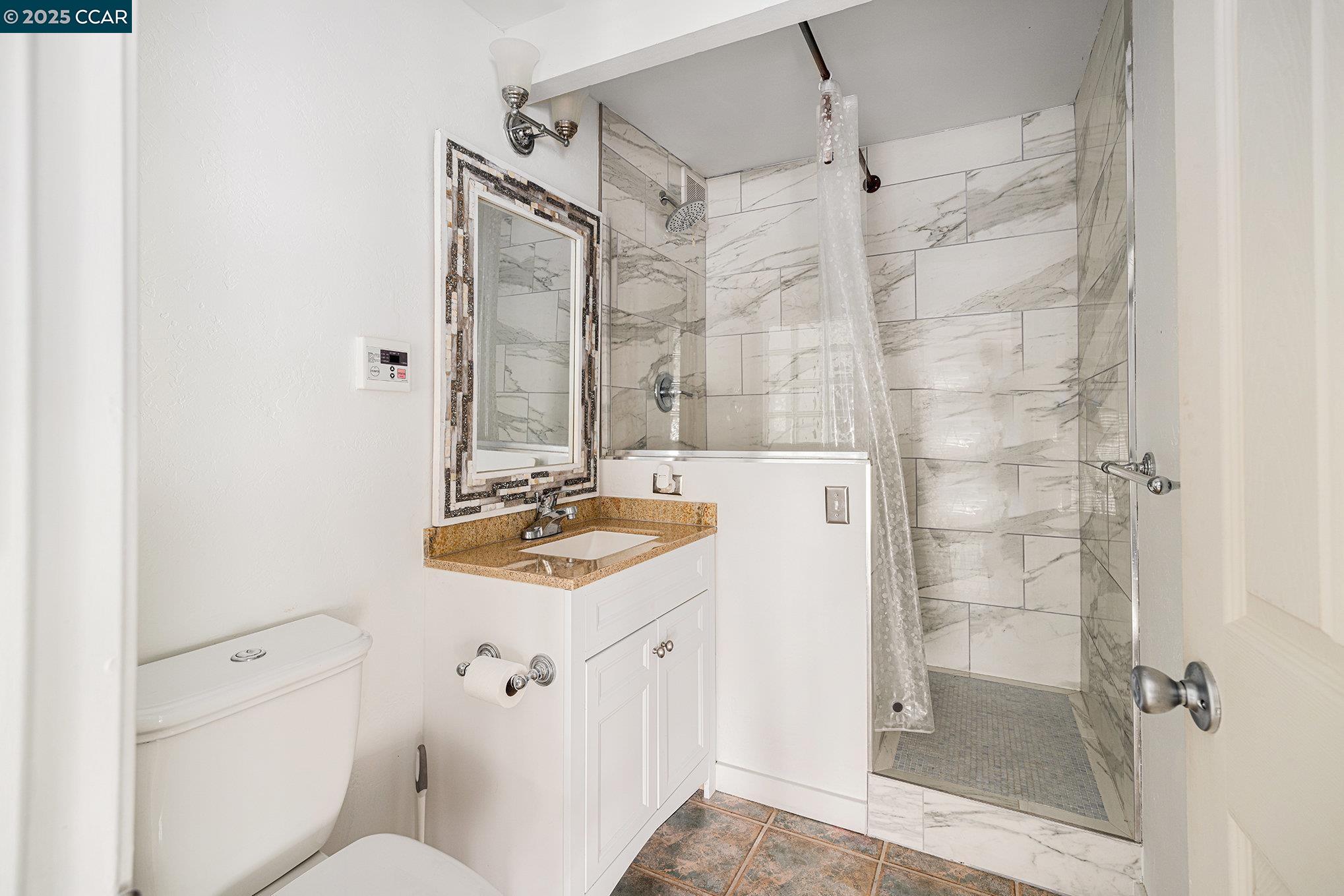 5955 Ralston Avenue Richmond, CA 94805 - Photo 42 of 47 a bathroom with a sink toilet vanity and shower