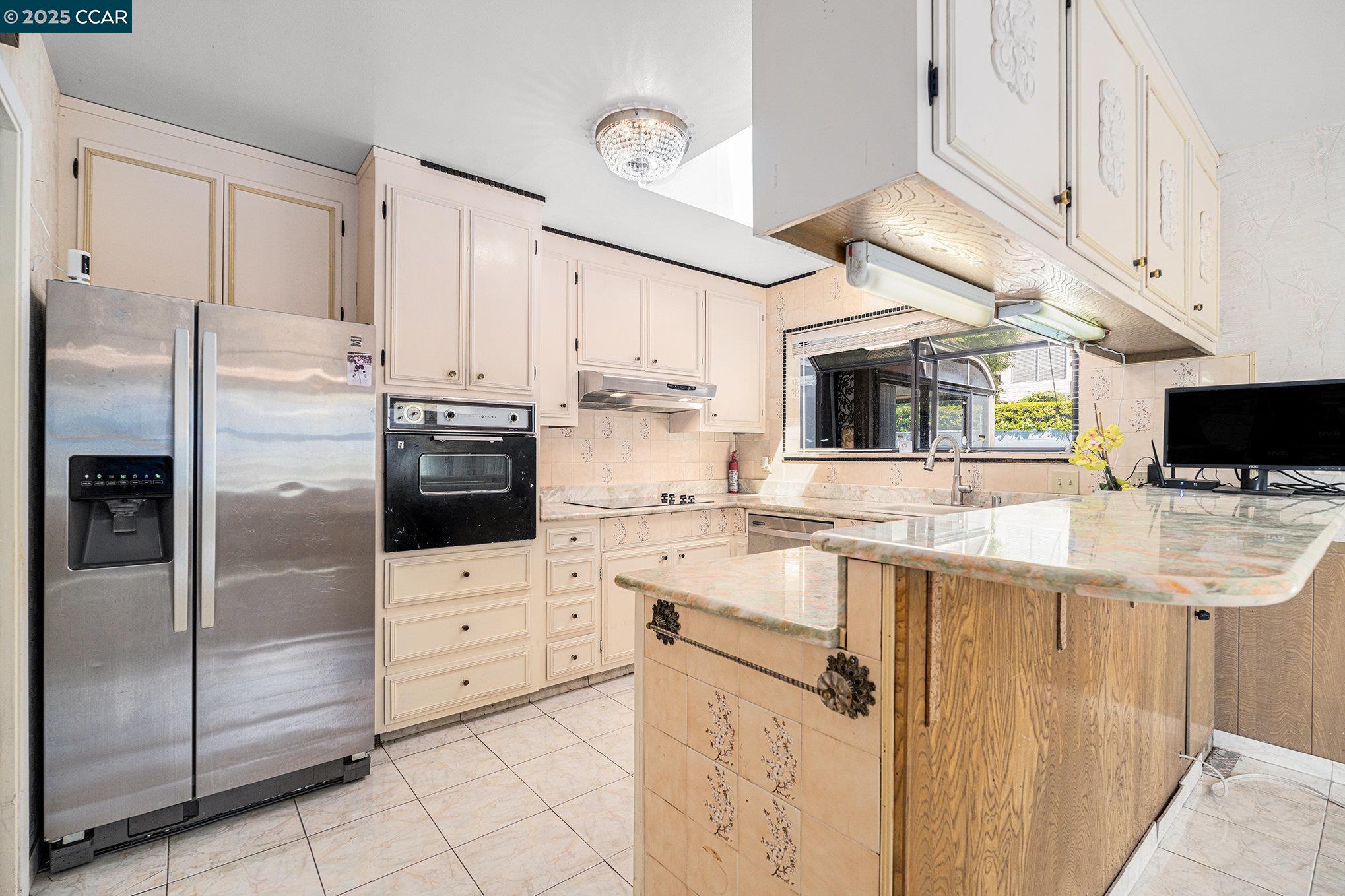 5955 Ralston Avenue Richmond, CA 94805 - Photo 10 of 47 a kitchen with stainless steel appliances a stove refrigerator sink and cabinets